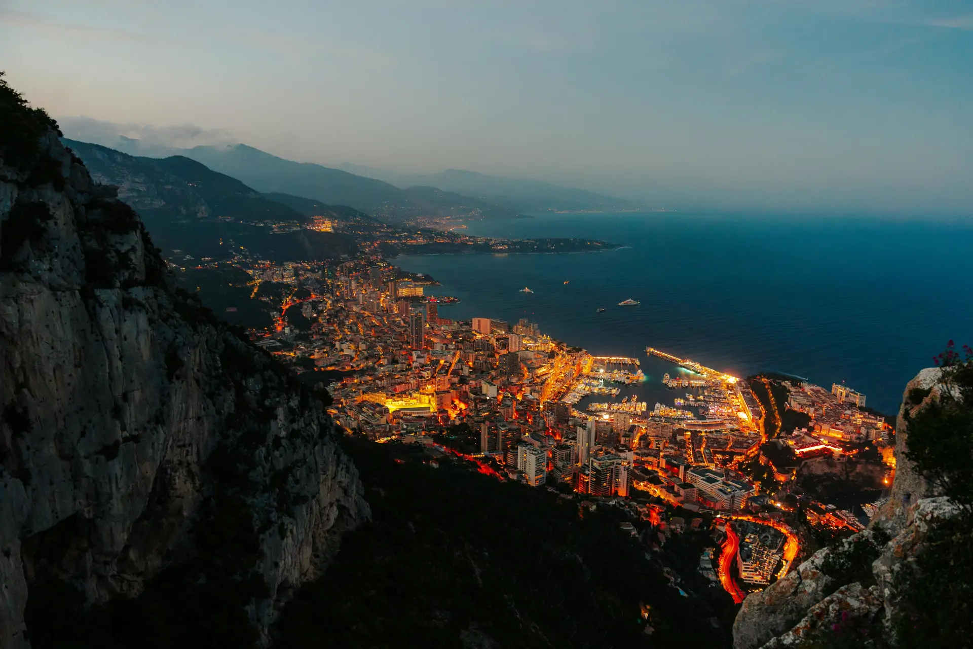 Monaco's elegant waterfront with luxury yachts docked against the backdrop of Monte Carlo's architectural splendor